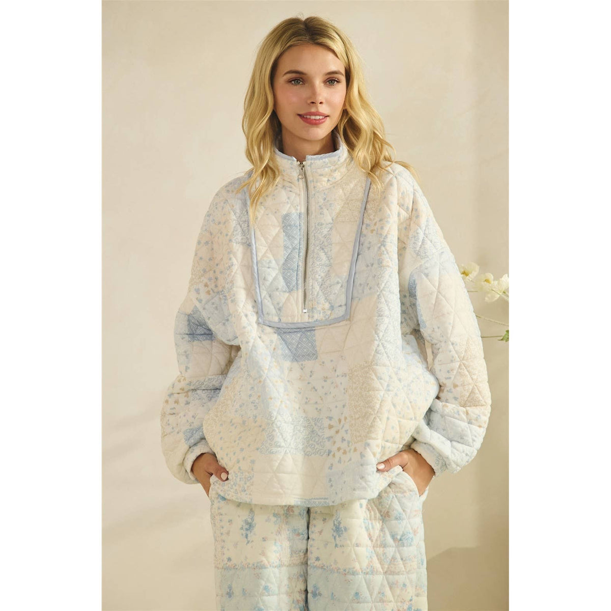 Floral textured quarter zip top